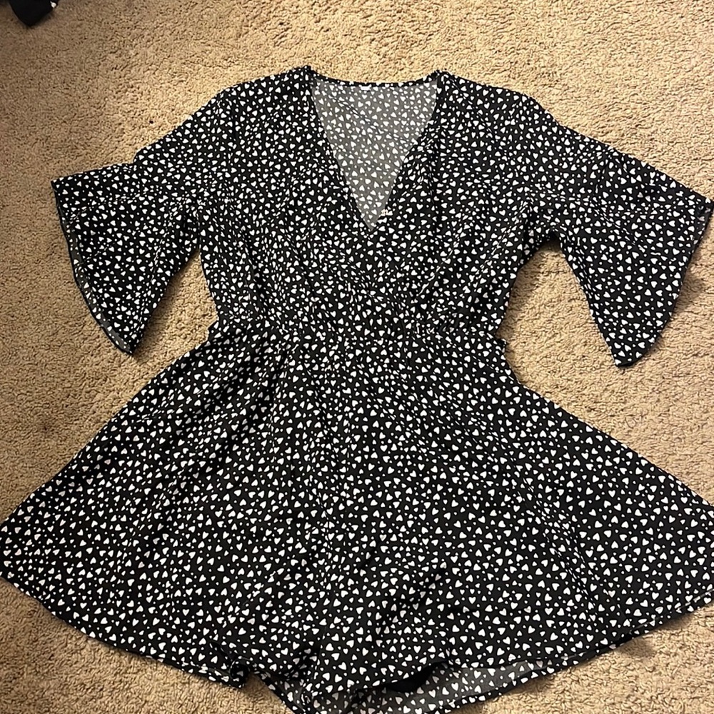 Medium black and white romper with little white hearts zipped up in back.